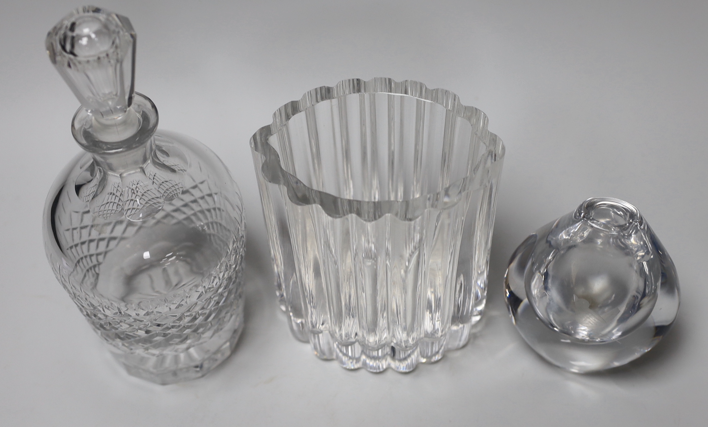 Three pieces of signed glass comprising a Kosa Boda vase by Eden Falk and an Orrefors decanter and vase, the largest 23cm high